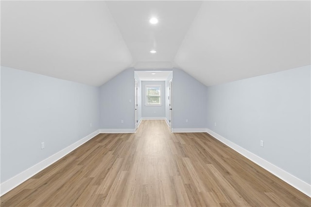 bonus room featuring light hardwood / wood-style flooring and vaulted ceiling