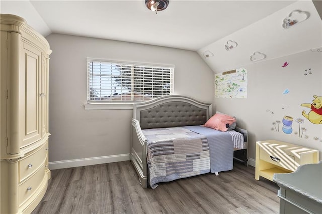 bedroom featuring wood-type flooring and vaulted ceiling