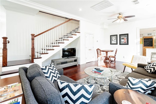 living room with dark hardwood / wood-style floors, ceiling fan, and ornamental molding