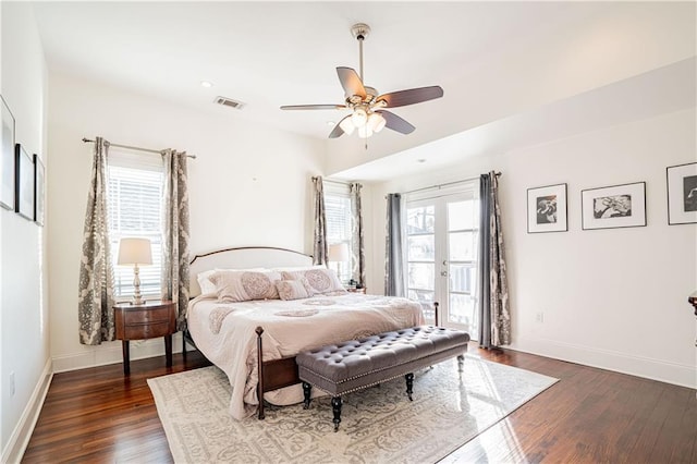 bedroom featuring multiple windows, access to exterior, dark hardwood / wood-style floors, and ceiling fan