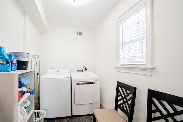 washroom with washer and dryer and a wealth of natural light