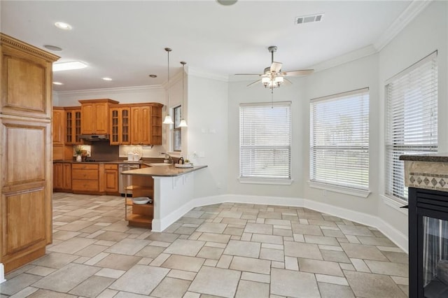 kitchen with pendant lighting, crown molding, a multi sided fireplace, a kitchen bar, and kitchen peninsula