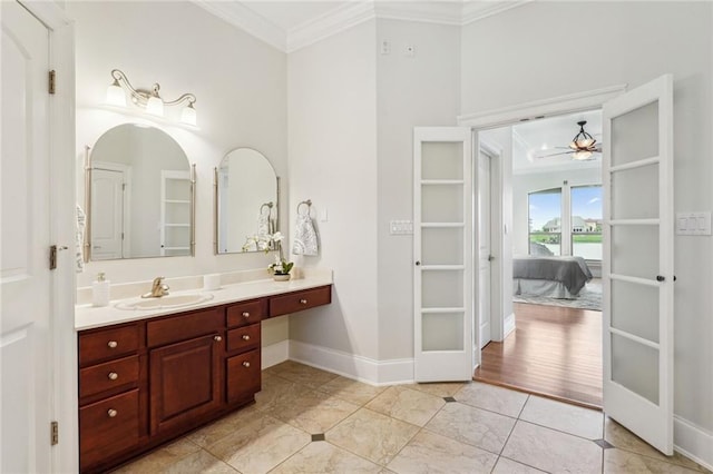 bathroom featuring tile patterned flooring, crown molding, vanity, and ceiling fan