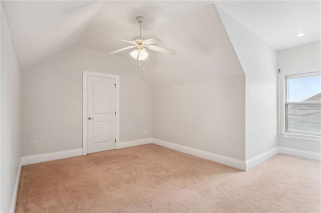 additional living space featuring lofted ceiling, light colored carpet, and ceiling fan