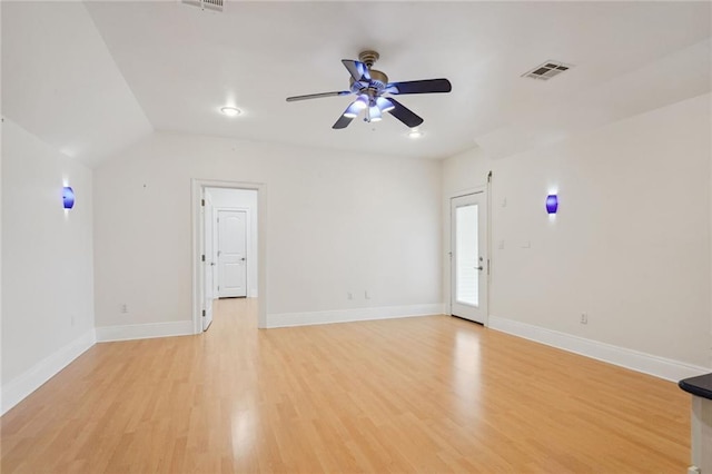 interior space featuring light wood finished floors, visible vents, a ceiling fan, and baseboards