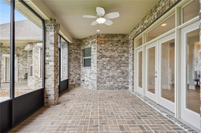 unfurnished sunroom with french doors and a ceiling fan