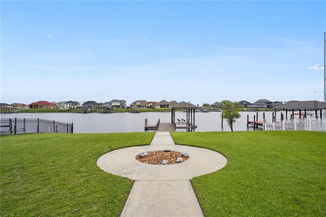 exterior space featuring a lawn, fence, and boat lift