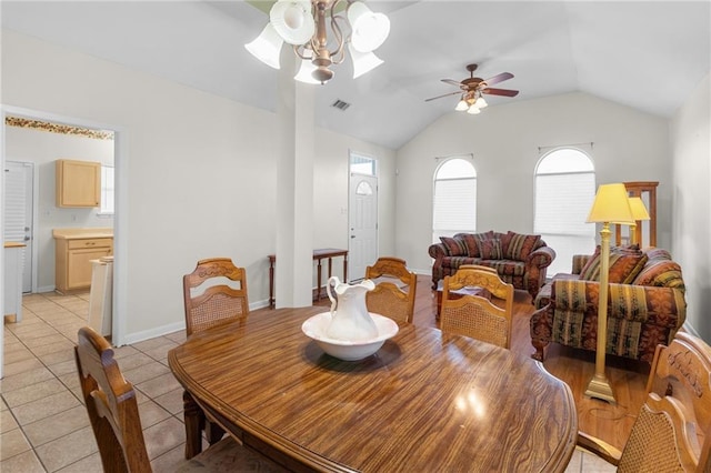 tiled dining area featuring vaulted ceiling and ceiling fan