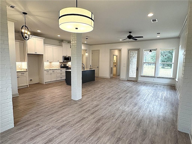 kitchen with white cabinets, ceiling fan, pendant lighting, and appliances with stainless steel finishes