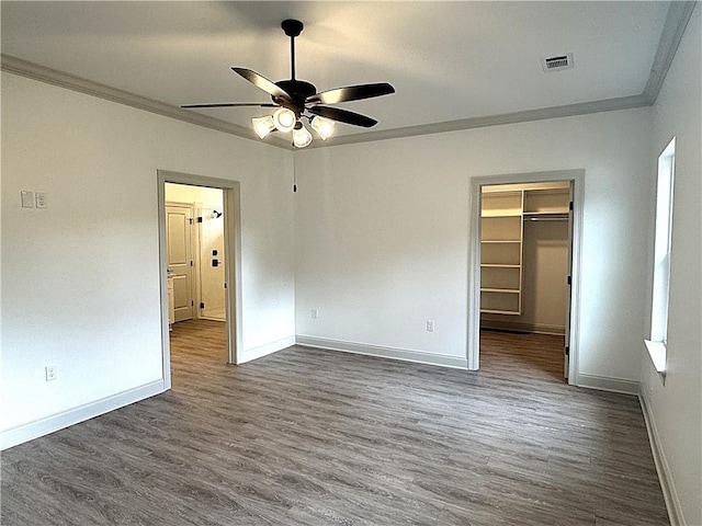 spare room featuring ceiling fan, crown molding, and dark hardwood / wood-style floors