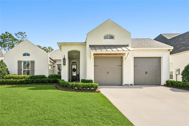 view of front of house featuring an attached garage, a front yard, a standing seam roof, metal roof, and driveway