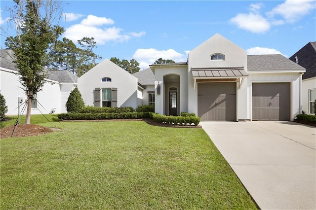 view of front of property with a garage, concrete driveway, a front lawn, and stucco siding