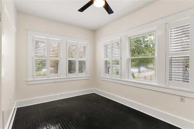 spare room featuring wood-type flooring and ceiling fan