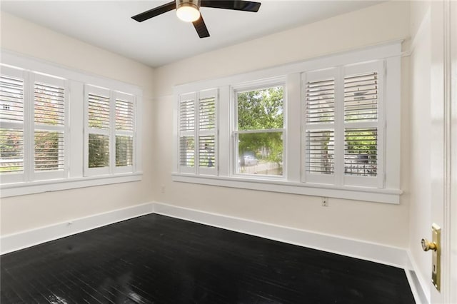 spare room with hardwood / wood-style flooring and ceiling fan