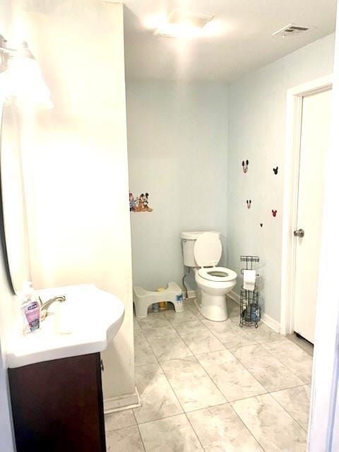 bathroom with vanity and toilet