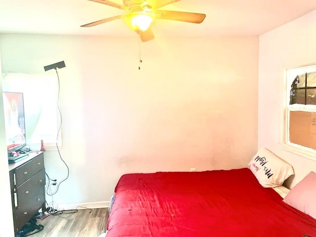 bedroom with hardwood / wood-style floors and ceiling fan