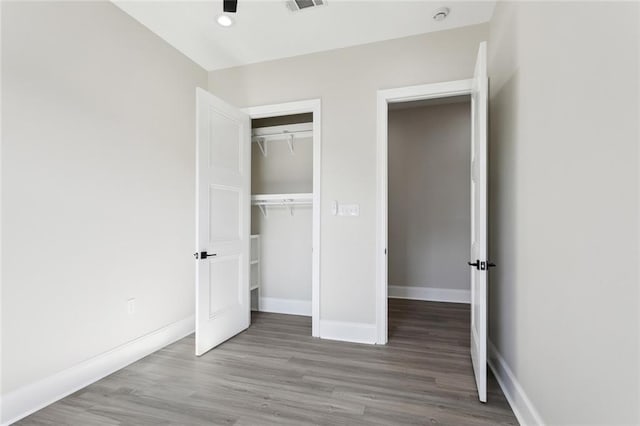 unfurnished bedroom with light hardwood / wood-style floors and a closet