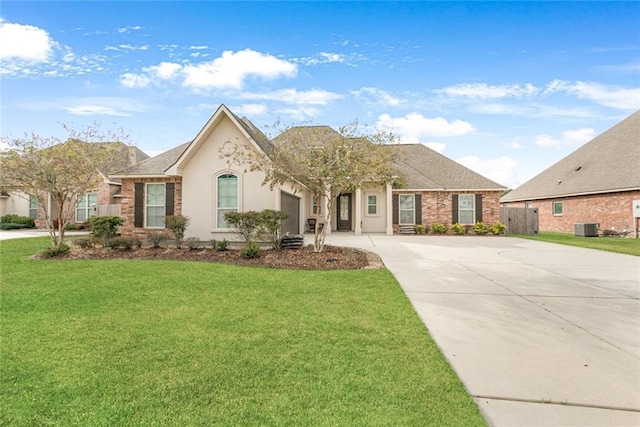 ranch-style house with cooling unit and a front yard