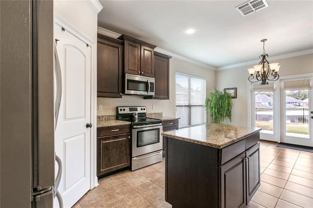 kitchen with plenty of natural light, a center island, appliances with stainless steel finishes, and an inviting chandelier