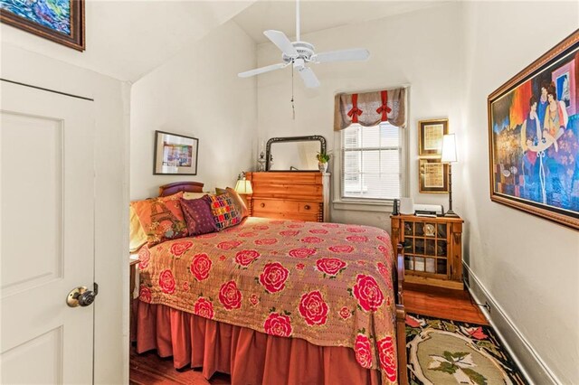918 Orleans Ave, New Orleans, LA 70116 - bedroom featuring baseboards, wood finished floors, vaulted ceiling, and a ceiling fan