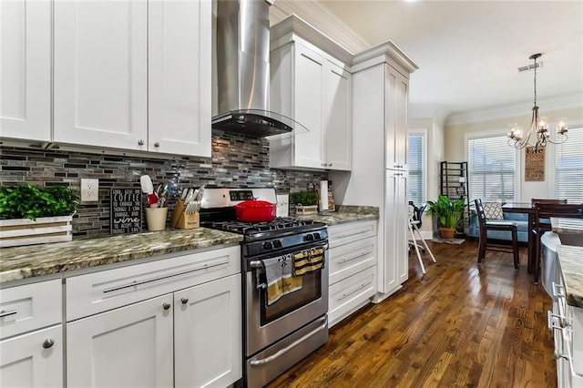 kitchen featuring an inviting chandelier, white cabinets, crown molding, wall chimney exhaust hood, and stainless steel range with gas stovetop