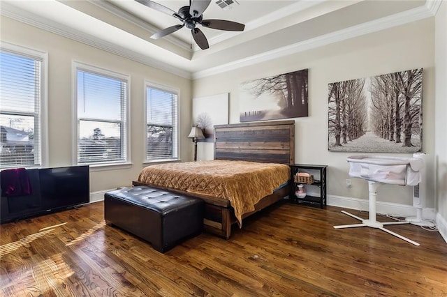 bedroom with dark hardwood / wood-style flooring, a tray ceiling, ceiling fan, crown molding, and multiple windows