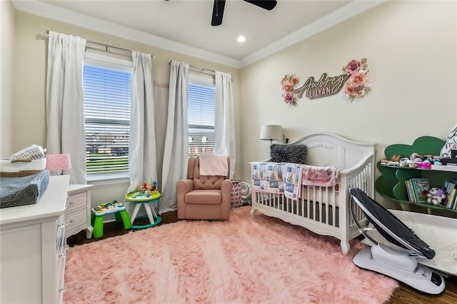 bedroom with ceiling fan and a crib