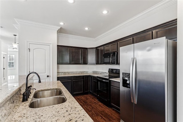 kitchen with light stone countertops, dark brown cabinets, sink, and black appliances