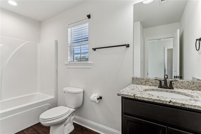 full bathroom with hardwood / wood-style flooring, vanity, toilet, and bathing tub / shower combination