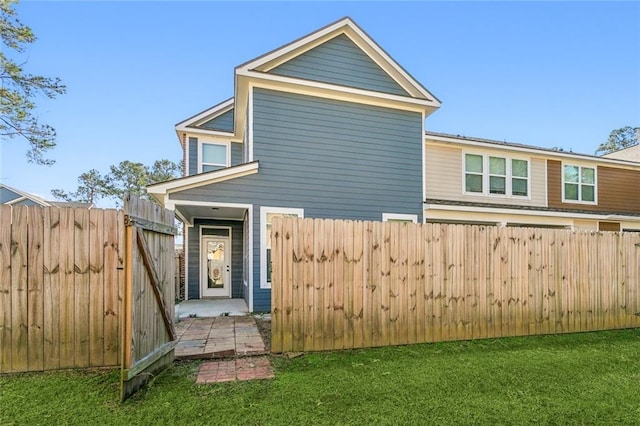 back of house featuring a yard