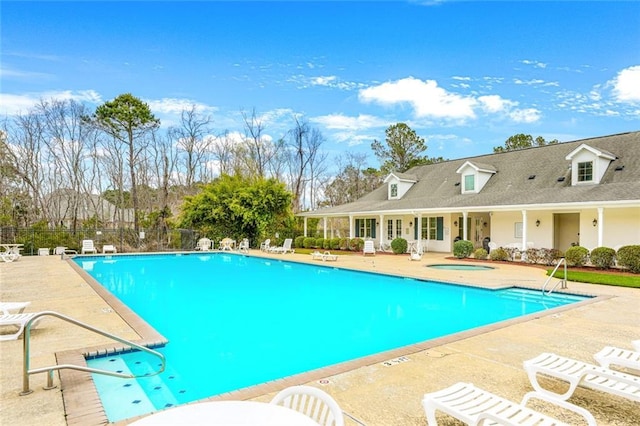 view of pool with a community hot tub and a patio area