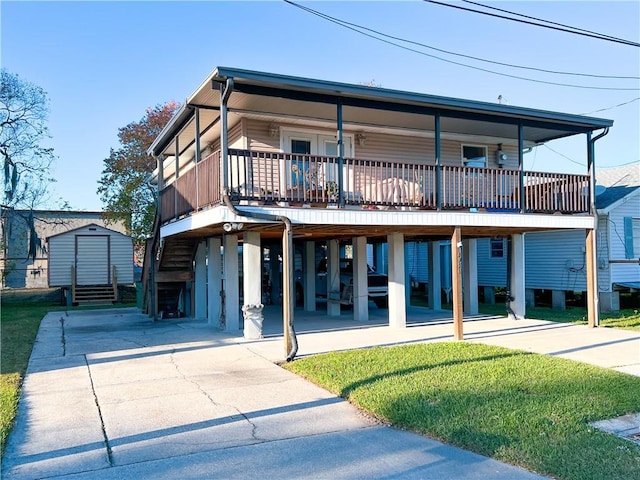 view of front of house with a carport and a storage shed