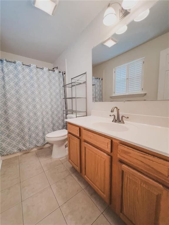 full bath featuring tile patterned flooring, curtained shower, vanity, and toilet