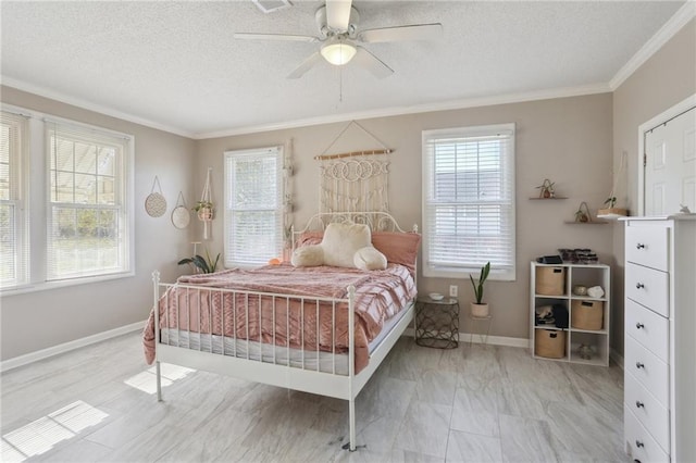 bedroom featuring ceiling fan, a textured ceiling, and ornamental molding