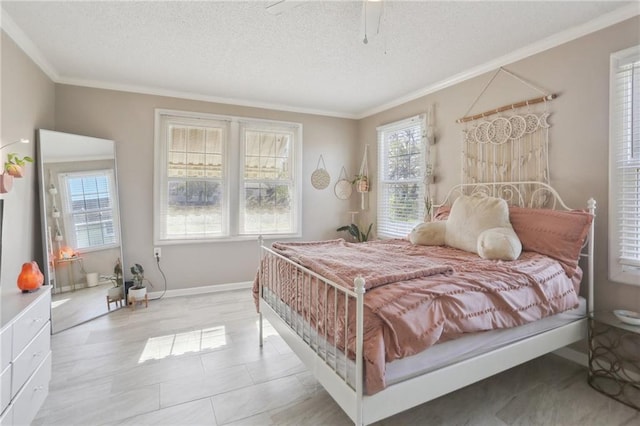 bedroom with ceiling fan, ornamental molding, and a textured ceiling