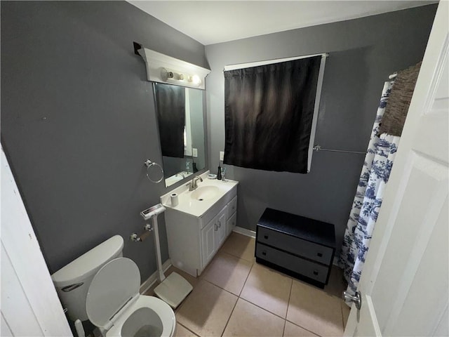 bathroom with tile patterned flooring, vanity, and toilet