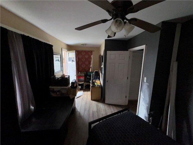 bedroom with hardwood / wood-style floors and ceiling fan