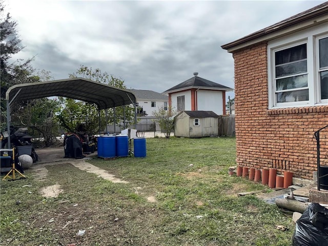 view of yard featuring a carport and a storage shed