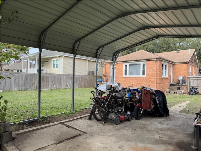 view of car parking featuring a yard and a carport