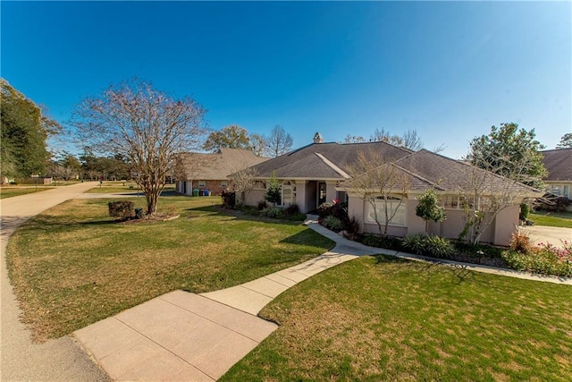 single story home with a front yard and a garage