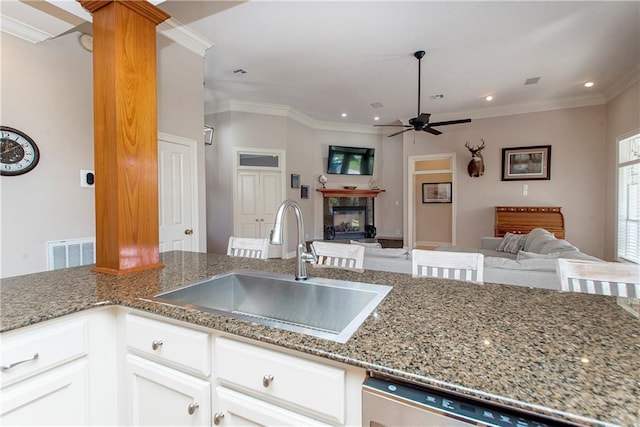 kitchen with ornamental molding, ceiling fan, sink, dishwasher, and white cabinets