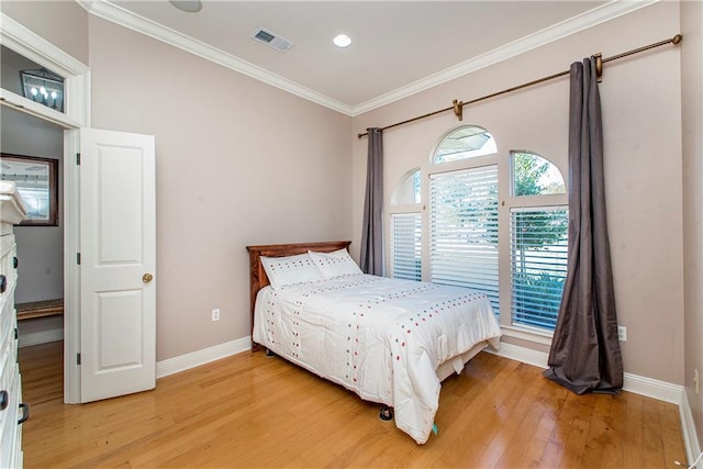 bedroom featuring hardwood / wood-style flooring and crown molding