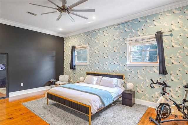 bedroom with ceiling fan, hardwood / wood-style flooring, and ornamental molding