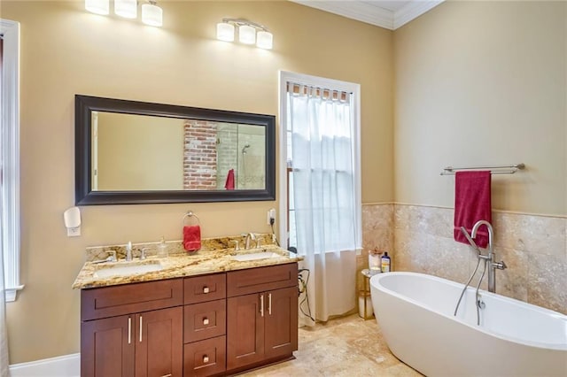 bathroom with vanity, a bath, and ornamental molding