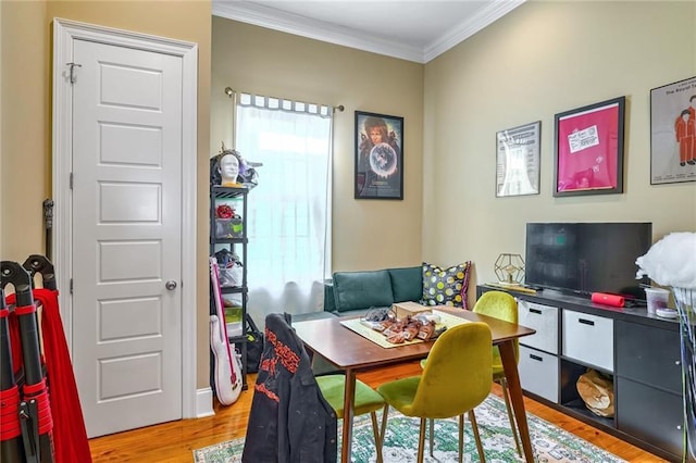 rec room with a wealth of natural light, ornamental molding, and light wood-type flooring