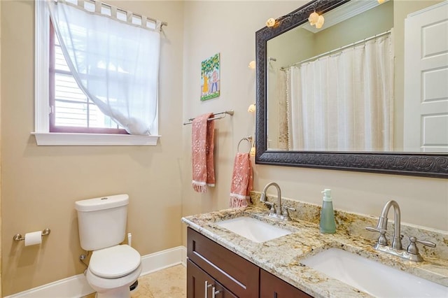 bathroom with tile patterned flooring, vanity, and toilet