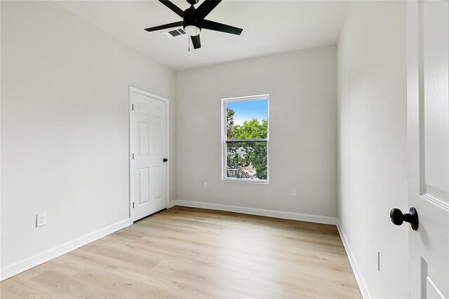 spare room featuring light hardwood / wood-style floors and ceiling fan