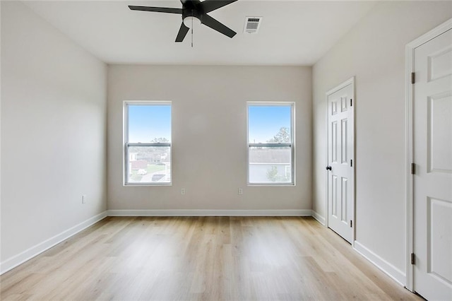 spare room with ceiling fan and light wood-type flooring