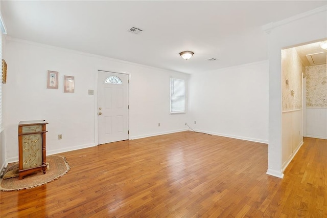 entrance foyer featuring light hardwood / wood-style floors and ornamental molding