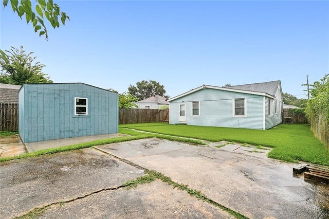 exterior space featuring a yard, a patio, and a shed